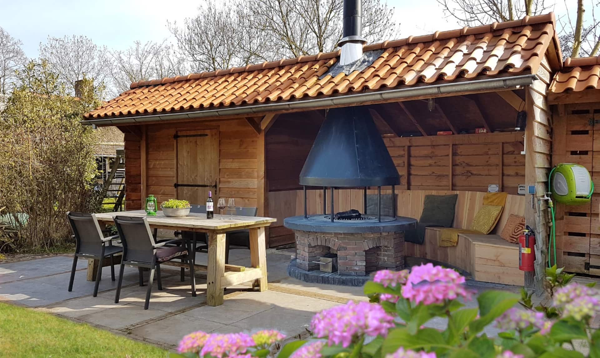 Overdekte buitenkeuken met eettafel